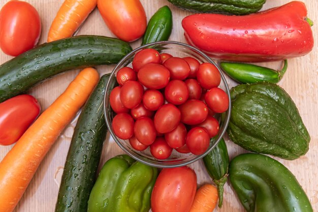 Carrot, cucumber, chayote, tomato and peppers on the table