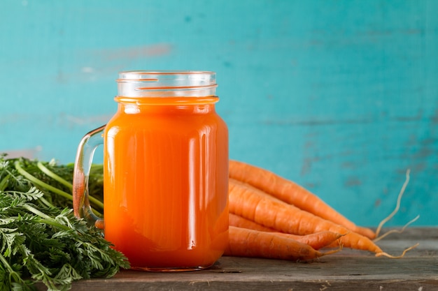 Carrot smoothie on table