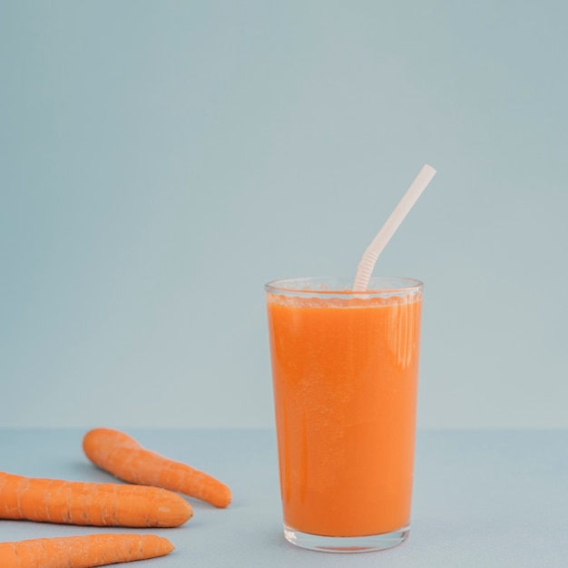 Carrot on table and carrot juice