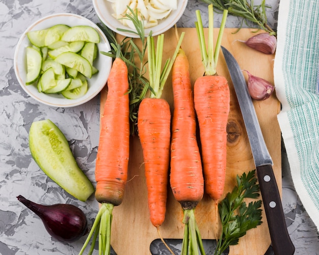 Carrots on wooden board top view