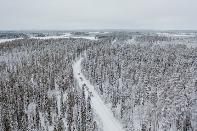 Cars driving through a mesmerizing snowy scenery in Finland