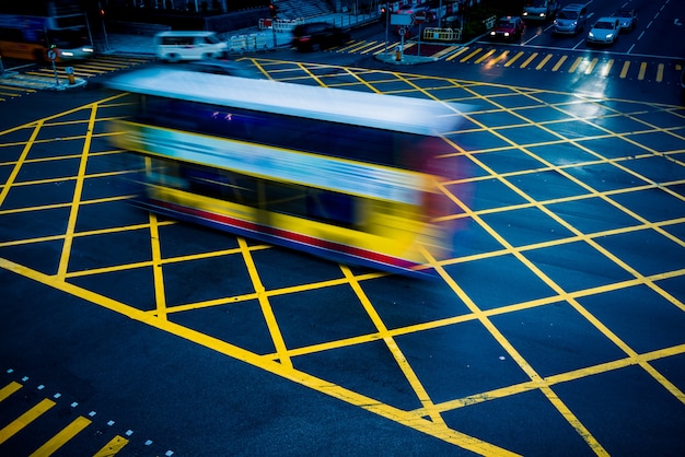 cars driving through yellow no parking area