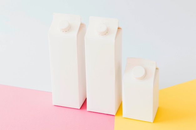 Carton milk packages on bright board