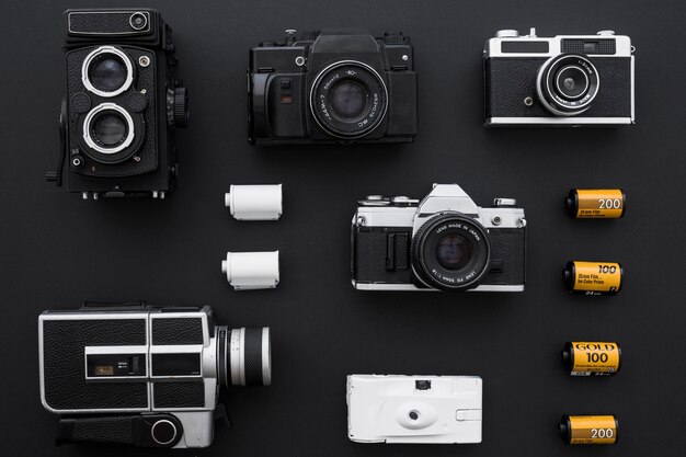 Cartridges near cameras on black background