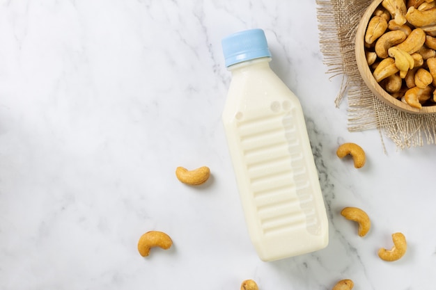 Cashew nut milk in bottle on table