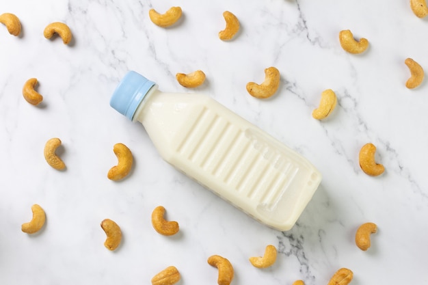 Cashew nut milk in bottle on table