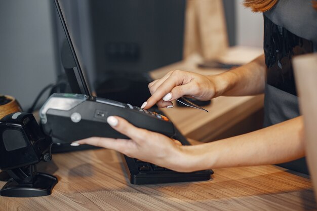 Cashier pays by card through the terminalThe cashier pays by card through the terminal.