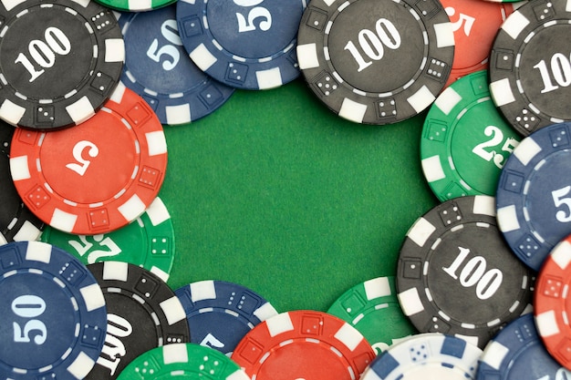 Casino tokens on green background with blank space