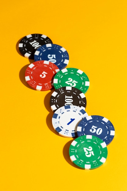 Casino tokens on yellow background