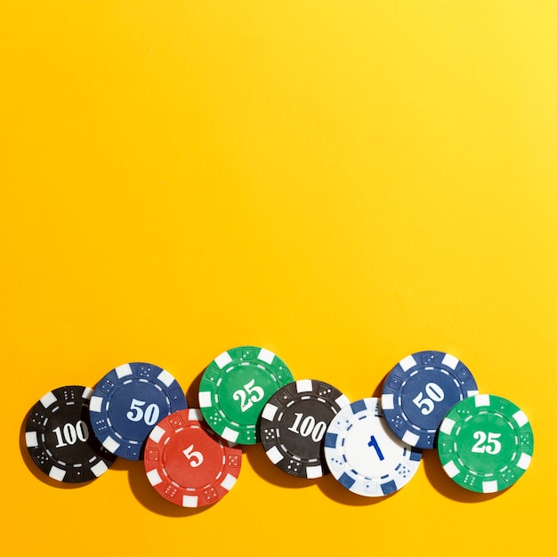 Casino tokens on yellow background