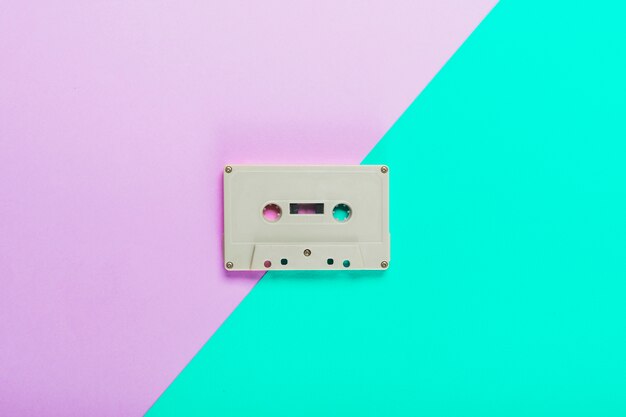 Cassette tape on dual purple and turquoise background