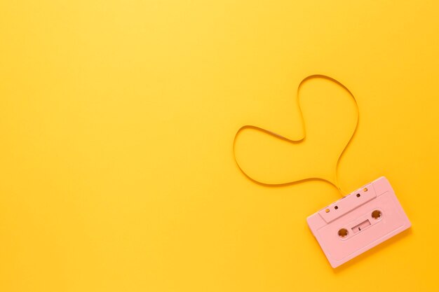 Cassette on yellow background with copy space