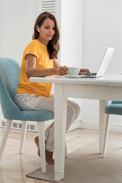 Casual adult woman working at home