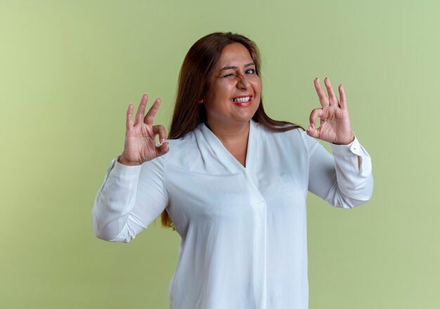 casual caucasian middle-aged woman showing okey gesture