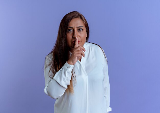 casual caucasian middle-aged woman showing silence gesture 