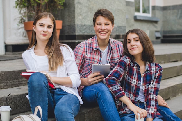 Casual content students posing on stairs