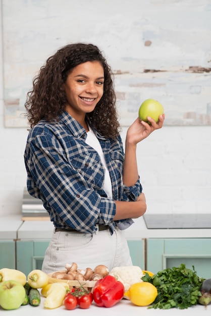 Casual dressed woman holding a apple