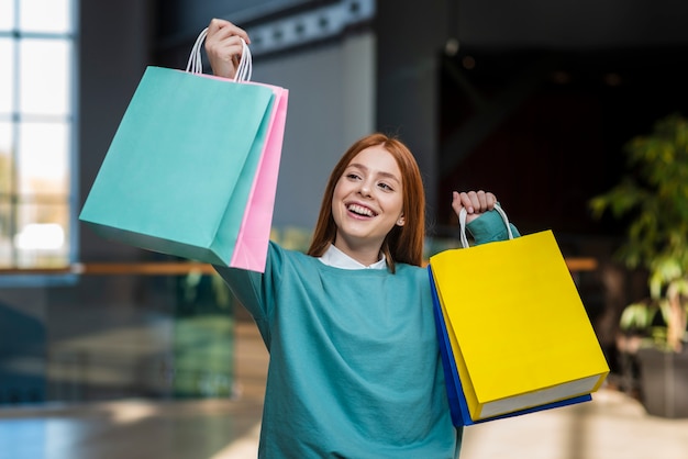 Casual dressed woman holding paper bags