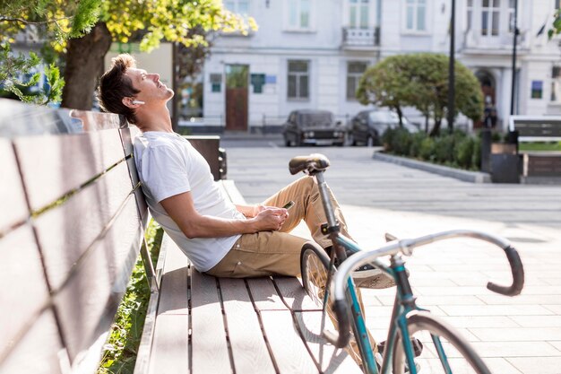 Casual male listening to music outdoors