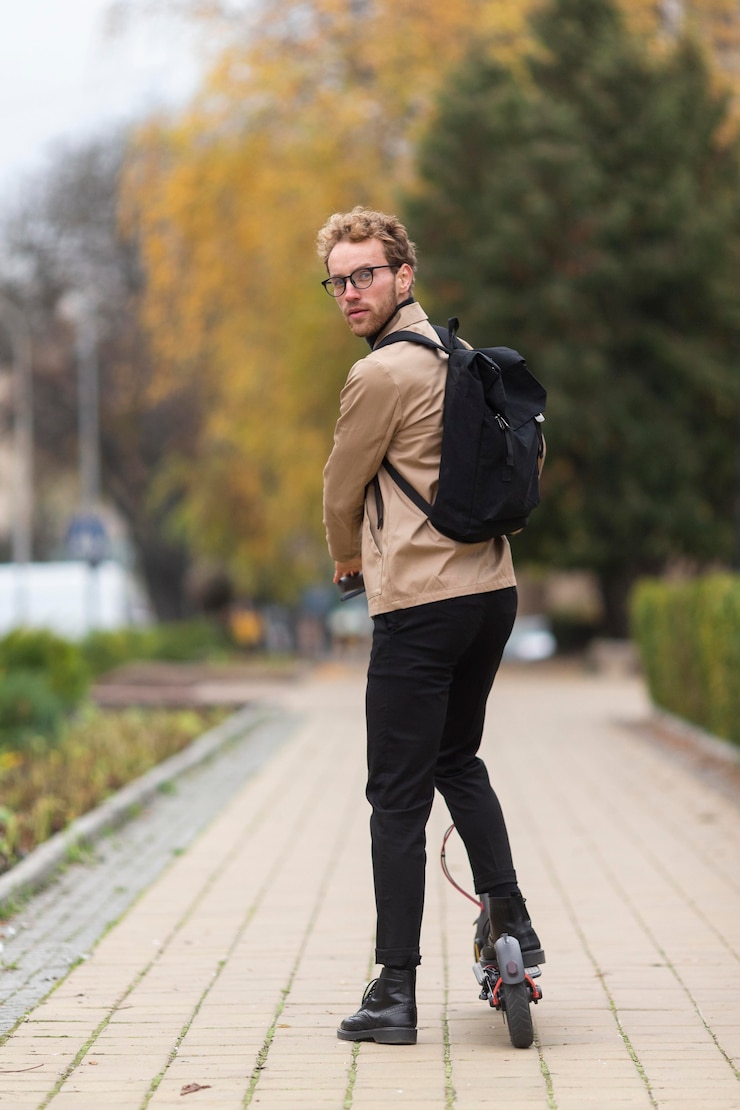 Free Photo casual male posing with an electric scooter