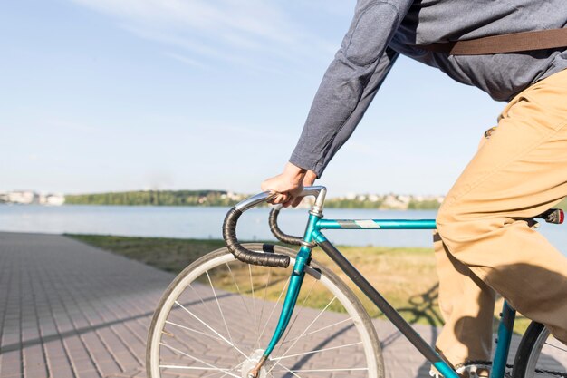 Casual male riding bicycle outdoors