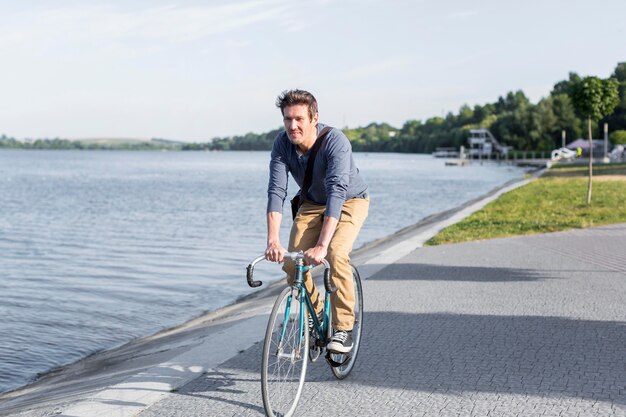 Casual male riding bicycle outdoors