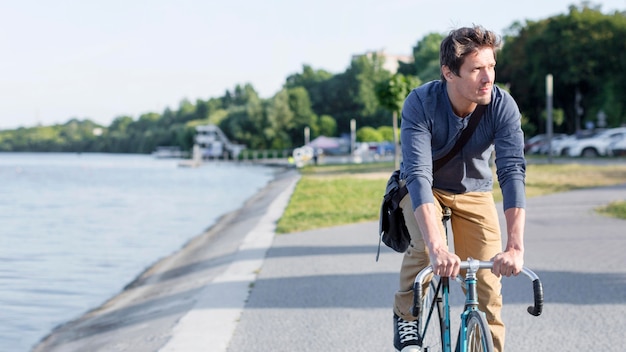 Casual male riding bicycle outdoors