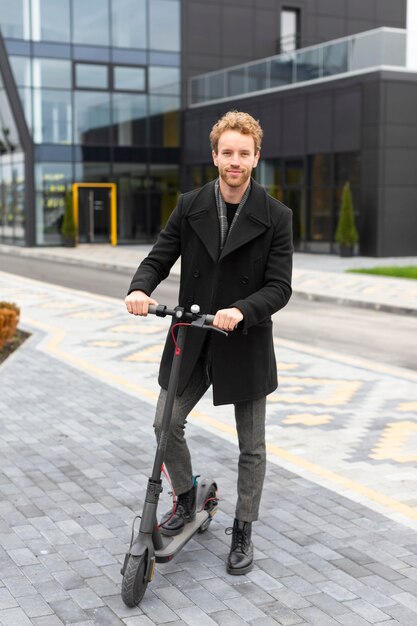 Casual male riding an electric scooter