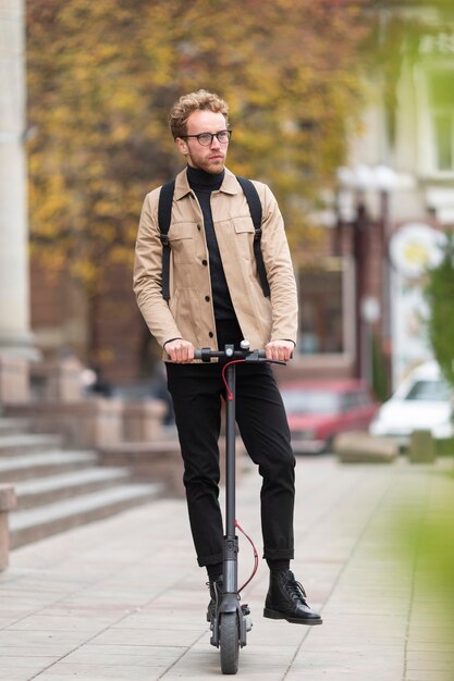 Casual male riding an electric scooter