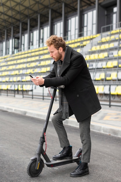 Casual male riding an electric scooter