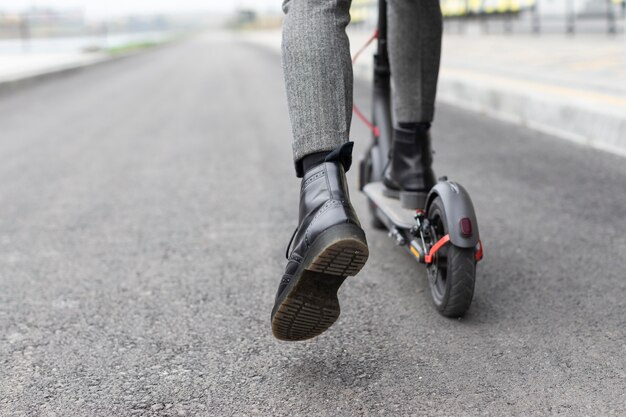 Casual male riding an electric scooter