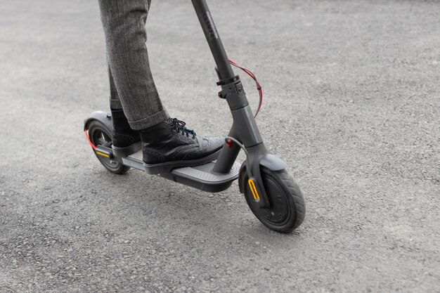 Casual male riding an electric scooter