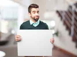 Free photo casual man holding a blank sign