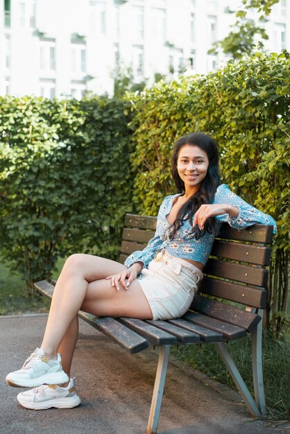 Casual outfit woman sitting on a bench