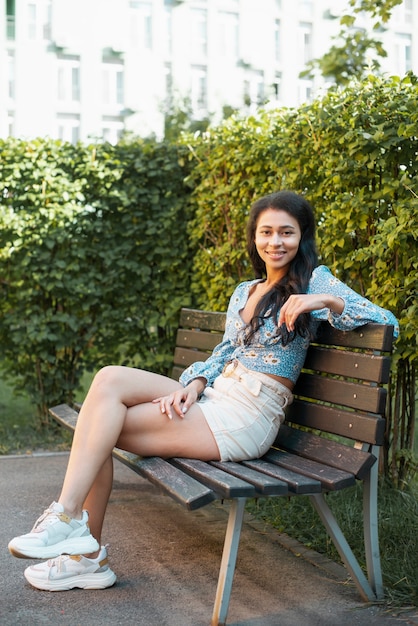 Casual outfit woman sitting on a bench