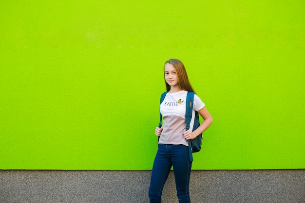 Casual schoolgirl standing with backpack