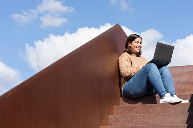 Casual teenager holding her laptop