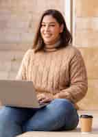 Free photo casual teenager holding her laptop