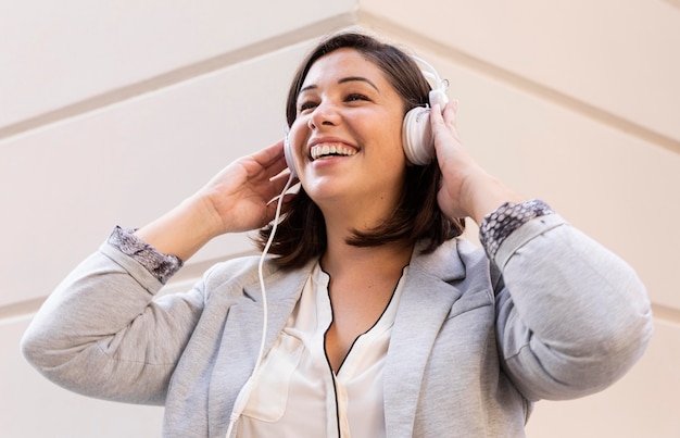 Casual teenager listening to music outdoors