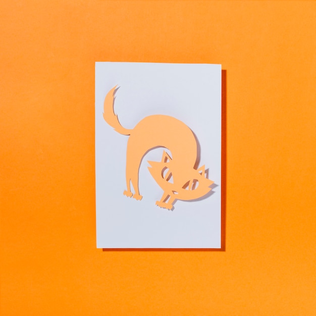 Free photo cat bending back on sheet of paper