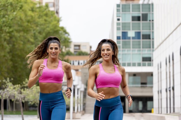 Caucasian athletic females running and doing morning workouts - healthy lifestyle concept