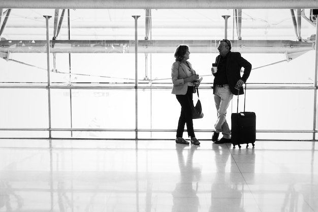 Caucasian couple talking together at the airport