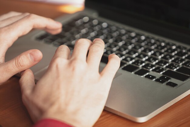 Caucasian entrepreneur, businessman, manager working in office, close up. Typing text, writing report or doing task. Concept of work, finance, business, success and leadership. Deadline, hurry up.