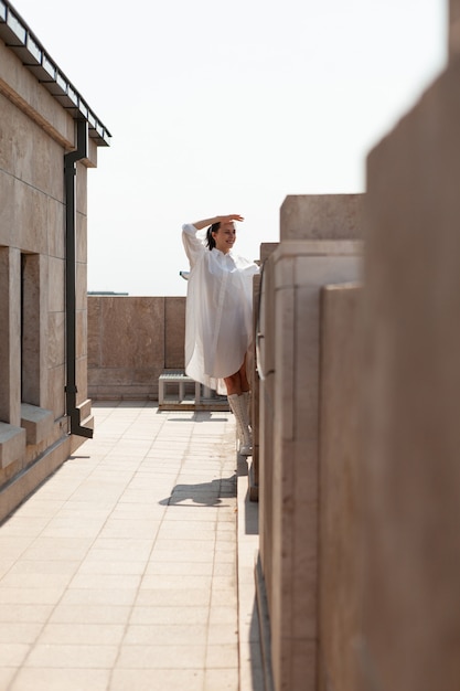 Caucasian female tourist looking at metropolitan city landscape view