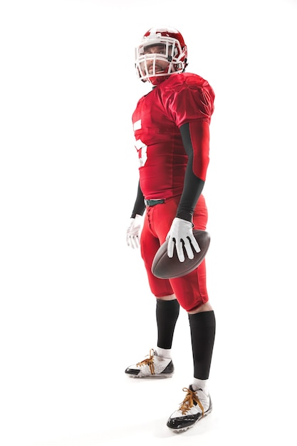 Caucasian fitness man as american football player holding a ball on white background