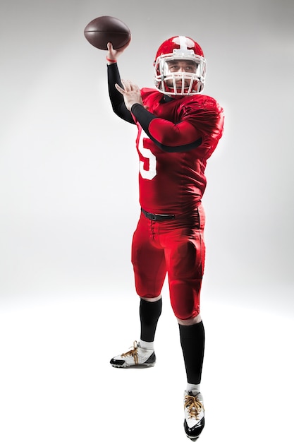 Free photo caucasian fitness man as american football player holding a ball on white