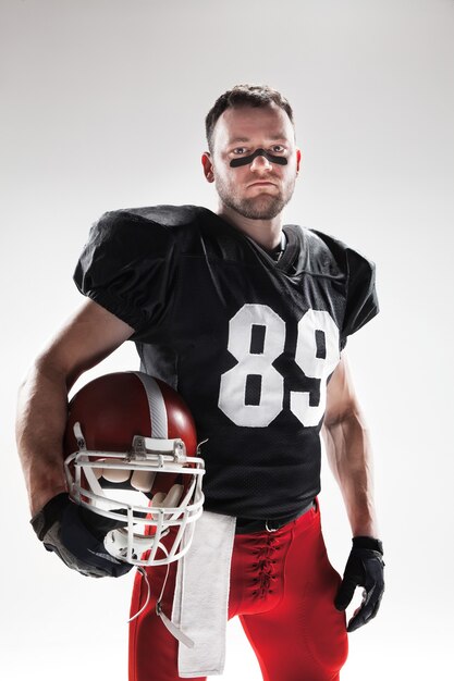 Caucasian fitness man as american football player  on white background