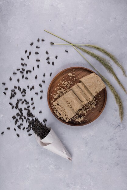 Caucasian halva made from sunflower seeds on a wooden platter