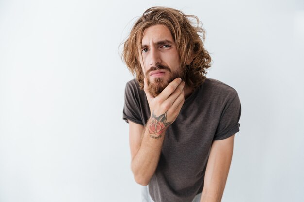 Caucasian handsome young bearded man standing isolated