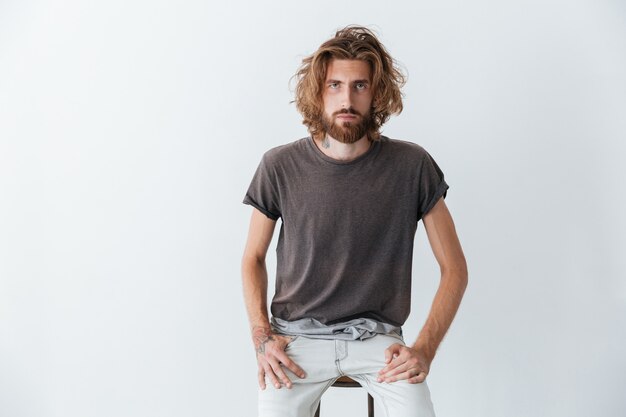 Caucasian handsome young bearded man standing isolated